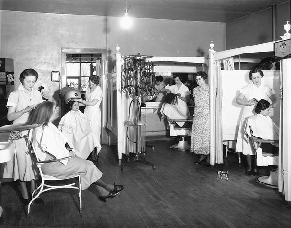 Hair stylists wearing the popular Marcel wave hairstyle create new looks for customers at the Marcel Comfy Shoppe, 1917 Winnebago Street near Schenk's Corners.