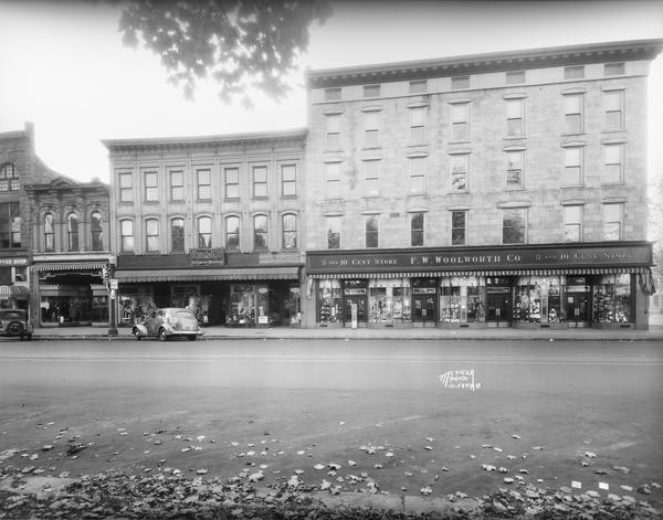 View of East Main Street, from right to left: F.W. Woolworth, 1-5 E. Main (aka Pioneer Building), Nu-Enamel Paint and Varnish, 7 E. Main, Rundell's, Inc., 9 E. Main, Diamond Brothers Women's Apparel, 11 E. Main, and Uphoff's Coffee Shop, 13 E. Main.