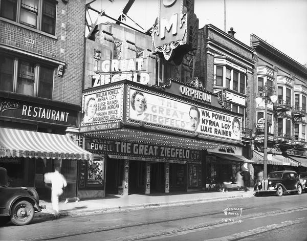 Orpheum Theatre marquee, 216 State Street, featuring William Powell, Myrna Loy and Luise Rainer in "The Great Ziegfeld." View also includes Weber's Restaurant and the Thom McAn shoe store.