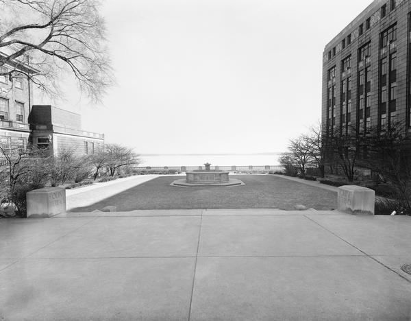 A view of Olin Terrace. The terrace and fountain were built in 1934 by CWA and FERA workers. It was designed by Frank Riley, Madison architect, in the Italian Reanissance style and funded by the John M. Olin Memorial Fund. John Olin was the founder of the Madison Park and Pleasure Drive Association. This site became the Monona Terrace Convention Center, designed by Frank Lloyd Wright.