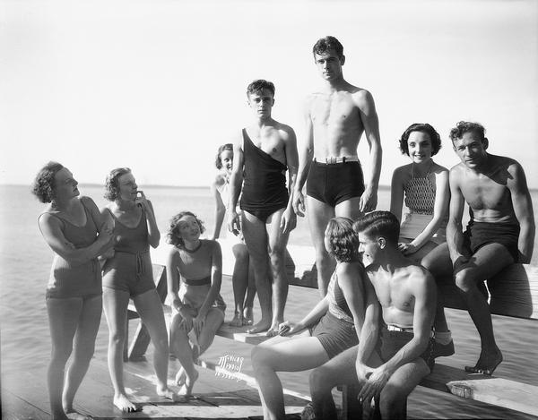 Standing on the Alpha Chi Omega sorority pier, Willard Grasser and Robert Estes show what is and is not permitted with regard to men's bathing suits. "The Capital Times" reported that Estes' abbreviated trunks have the approval of Police Chief McCormick, but Grasser's dropped shoulder strap violates Madison's code of decency. "If the suit has shoulder straps, the straps must stay on the shoulders."