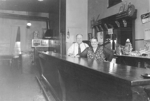 Bartender couple pose behind bar at Rose's Bright Spot on Highway 35, south of Fountain City.