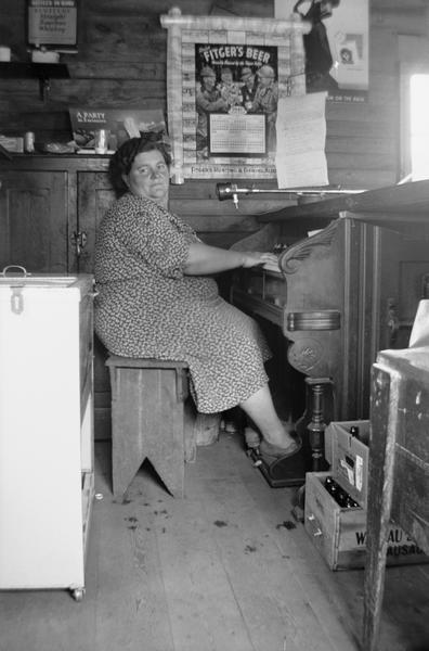 Side view of Bessie Gordon sitting at the organ.