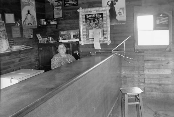 View across counter towards Bessie Gordon sitting at the organ.