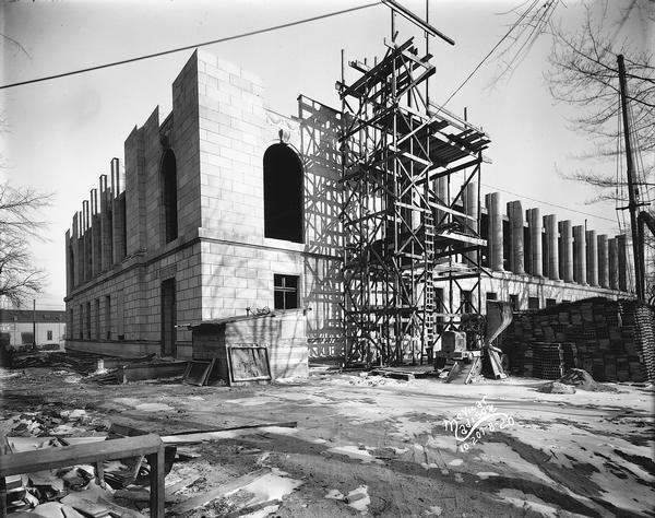 U.S. Post Office under construction at 215 Monona Avenue. Scaffolding is in place as stone walls and pillars rise on the second floor, in a view of the front, looking east from Monona Avenue.
