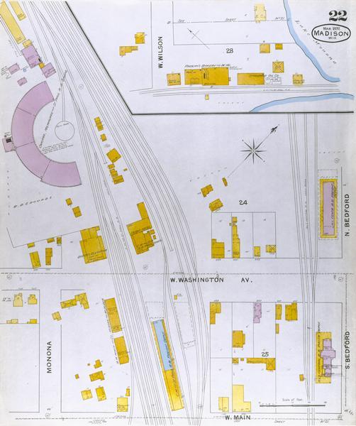 Detail map including West Washington Avenue, West Main Street, West Wilson Street, and North and South Bedford Streets. Includes the Chicago, Milwaukee & St. Paul Railroad roundhouse at the northwest corner of West Washington and Regent Street.