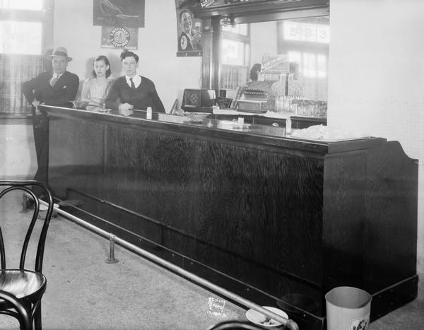 Two men and woman behind the bar at DiMartino's "Stone Front" Tavern. The bar was located at 533 Regent Street in the Greenbush neighborhood, and was owned by Tony and Celia Schiavo.