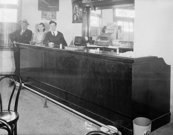 Two men and woman behind the bar at DiMartino's "Stone Front" Tavern. The bar was located at 533 Regent Street in the Greenbush neighborhood, and was owned by Tony and Celia Schiavo.
