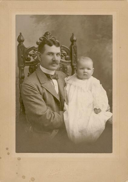 Samuel Sturgis II holding his baby son, Samuel Sturgis III.