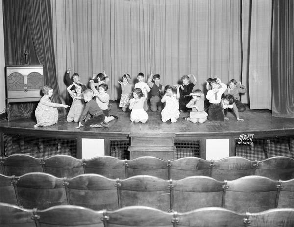 Longfellow School children on stage perform a scene from the folk play "The Hare and the Hedgehog." Longfellow School is located in the Greenbush neighborhood.
