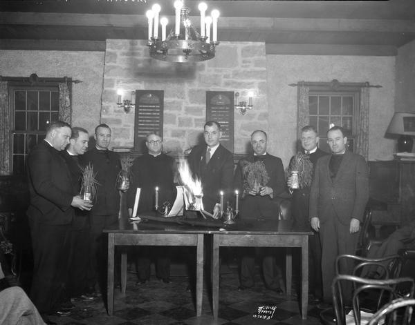 The Board of Directors burning the mortgage for the Nakoma Country Club to celebrate paying it off, with l-r: H.M. Lambert, Frank Davies, Carl Laughnan, H.M. DeGolier, chaplain, Mr. Steinhauer, A.R. Meek, W.H. Negley and W.P. McCubbin. It became the Nakoma Golf Club in 1944.