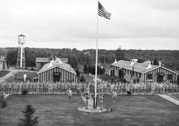 Men standing at attention as the flag is raised at Long Lake C.C.C. Camp F.