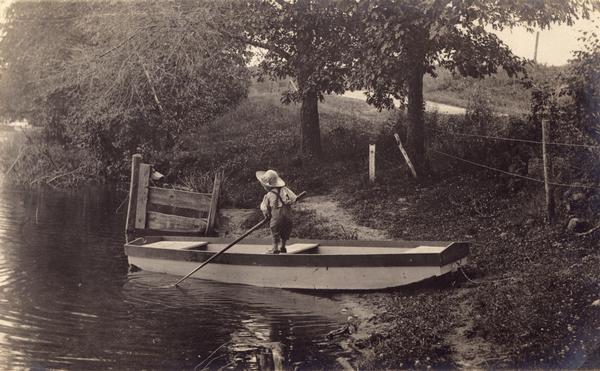 Laurie Peterson, son of the photographer, plays in boat. The photograph was originally titled "The Lone Boatsman".