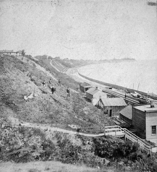 View of bluffs and buildings on the shore of Lake Michigan.