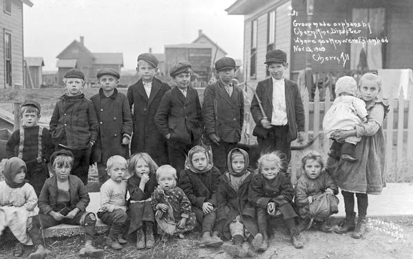 Photographic postcard of a posed group of orphan children of miners from mine disaster, Nov. 13, 1909. Caption reads: "#31 Group made orphans by Cherry Mine Disaster Where 400 Men were Entombed Nov 13, 1909 Cherry, Ill."