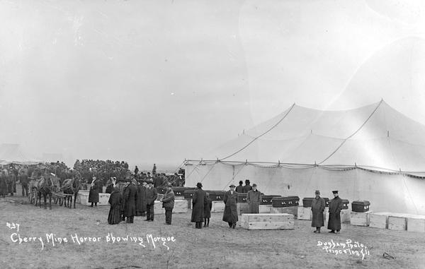 Photographic postcard of funeral and tent/morgue from the Cherry Mine disaster. Caption reads: "#37 Cherry Mine Horror Showing Morgue Dunham Photo Princeton, Ill."