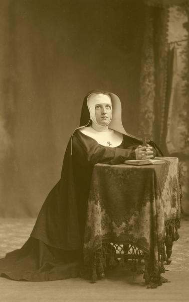 Jennie (Jane) A. Kyle, member of the Menomonie High School class of 1905, depicted as a nun. Part of a yearbook created by classmate Albert Hansen, based on a class prophecy theme.