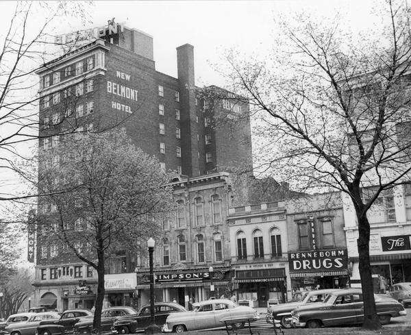 View from Capitol Square Park of the Belmont Hotel and nearby buildings. Includes the storefronts for Simpson's and Rennebohm Drug Store #6, at 19 North Pinckney.
