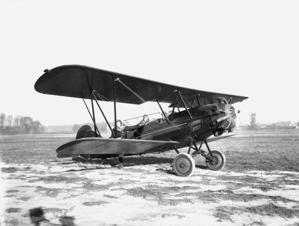 Pilot O.G. Corben preparing to take off with photographer Aldro Wasley and another passenger on their way to the Wisconsin-Purdue football game in Lafayette, Indiana. After the game, Corben was to fly Wasley back to Madison so his pictures of the game could appear in the <i>Capital Times</i>.