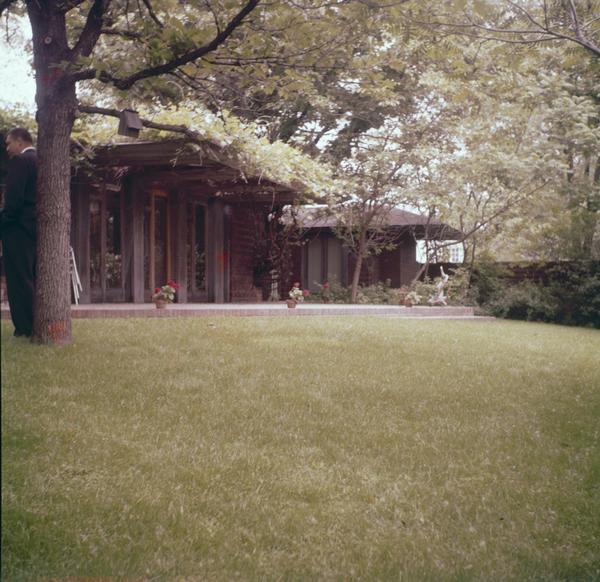 South elevation of the Malcolm Willey showing the terrace, the gardens, the glass doors off the living room, and the bedroom wing in the background. The Malcom Willey residence was designed by Frank Lloyd Wright.