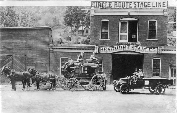 Six men posed with a stage coach and an International F-31 truck in front of the Circle Route Stage Line and Beaumont Stables storefront. The line ran from Oury to Silverton in Colorado.