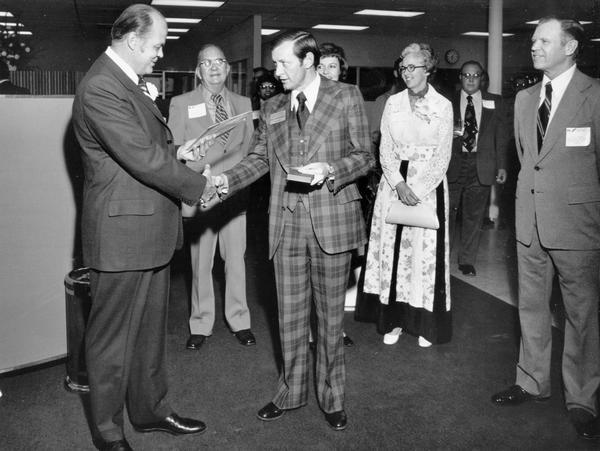 Original caption reads: "K.P. Mazurek (left), President, International Harvester's Truck Division, receives the key to the city of El Paso, Texas, from Mayor Pro Tem Don Henderson, during the grand opening of International trucks' new sales and service branch operation, 1341 Lomaland Drive, El Paso, Texas. Looking on are Mrs. Mazurek and D.K. Headley, manager or the IH truck Dallas sales region."