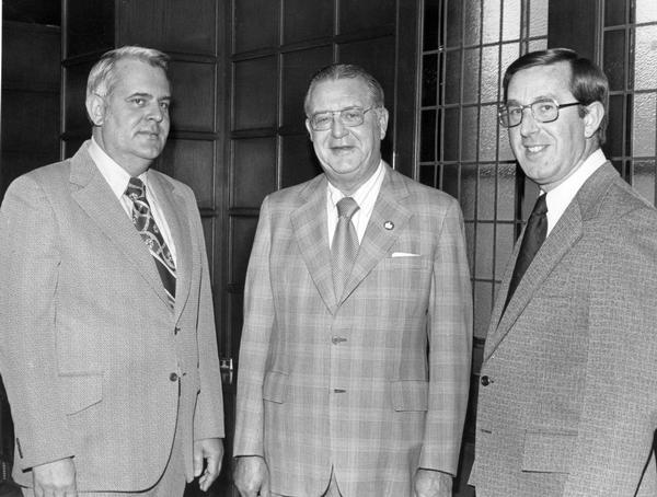 Original press release caption reads: "J.O. Hill (right), of O.S. Hill and Company, International truck dealer at East Liverpool, Ohio, was recently elected chairman of the International truck dealer council. Chuck Imbler (left), outgoing chairman, and R.L. McCaffrey, Vice President, Marketing, for International Harvester's Truck Division, congratulate Hill. The twelve regional representatives of the 2,200 International truck dealers in the United States met in Chicago recently with IH officials to exchange ideas on a variety of marketing and dealer-management relations topics a the company's 9th annual National Dealer Conference."