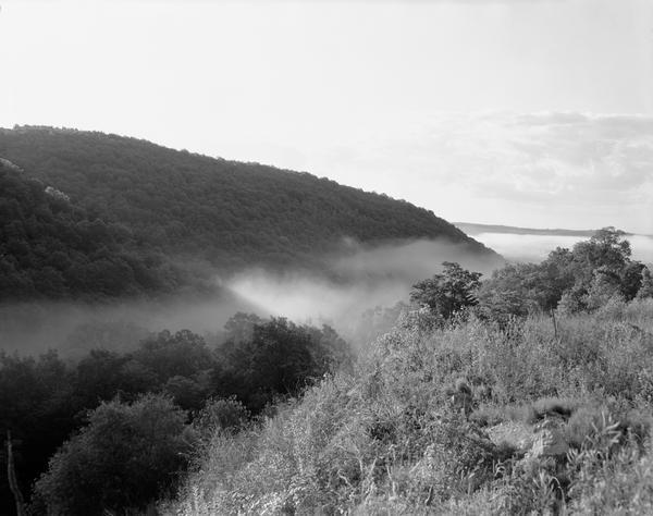 Hills and fog at sunrise, looking out from the north side of the Wisconsin River.