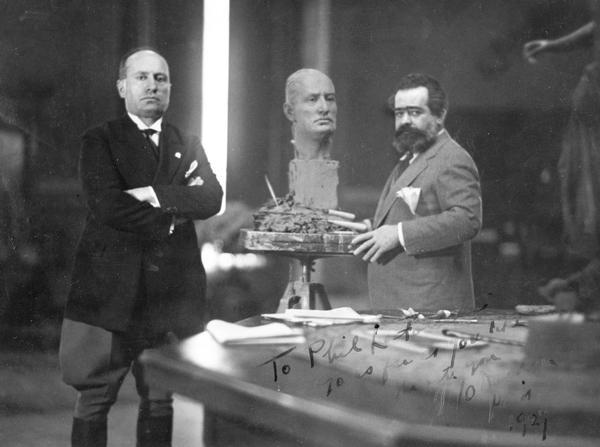Sculptor Jo Davidson stands with Benito Mussolini and his bust-in-progress of Mussolini.