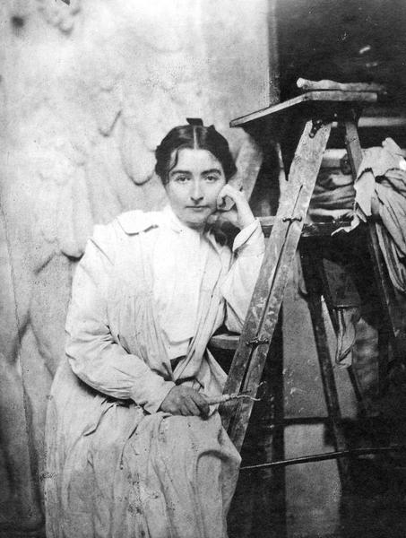 Helen Farnsworth Mears sitting on a ladder and resting her head against her hand.