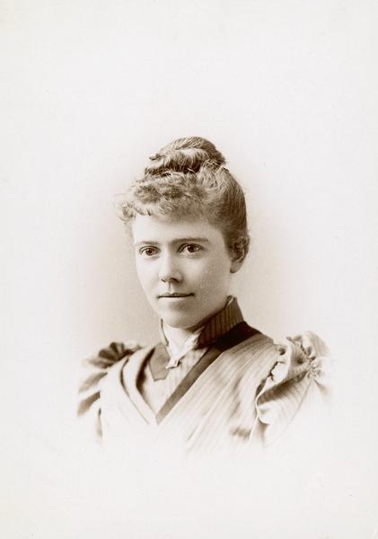 Vignetted head and shoulders studio portrait of Harriet Bell Merrill.