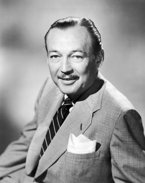 Headshot of Jack Bailey wearing a suit and tie. He was the master of ceremonies for the 1950s daytime TV show "Queen for a Day," which ran on NBC from 1956 to 1960, then on ABC from 1960 to 1964. The show was derived from the radio show "Queen For Today," on the air from 1945 to 1957.

