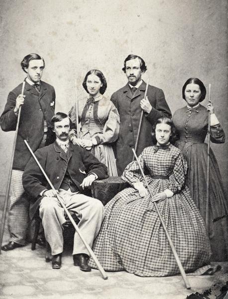 Portrait of Loyd G. Harris and family holding pool cues.