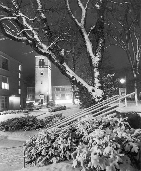 Nighttime winter scene on University of Wisconsin-Madison campus of the Carillon Tower with the Social Sciences building in the background.