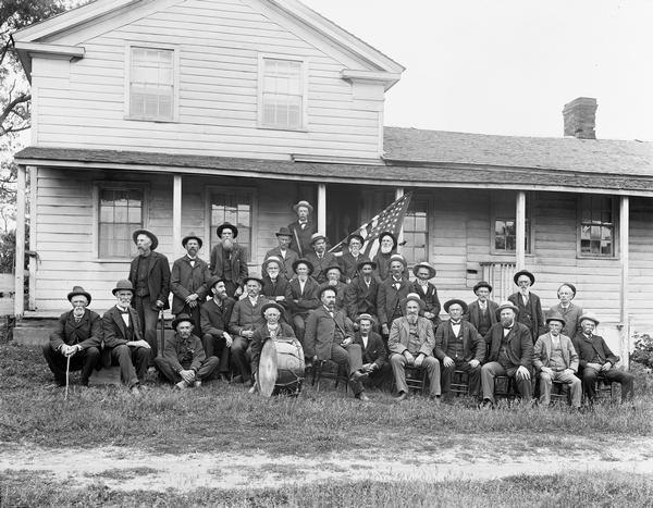 Portrait of the veterans of Company E, 12th Wisconsin Volunteer Infantry at their reunion. H.H. Bennett appears standing at the far right of the second row.