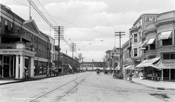 View down East Grand Avenue of the business district with a shoe business at the end of the street and the Hilton Hotel to the left.