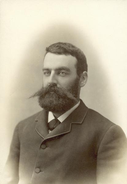 Studio portrait of Edward Thomas Owen in suit, with full moustache and beard.