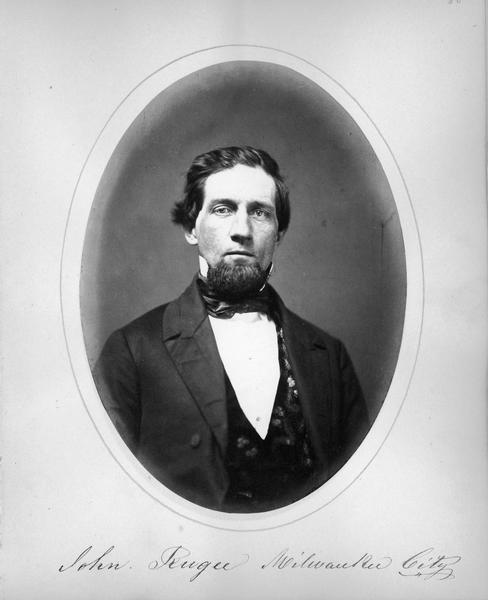 Quarter-length studio portrait of John Rugee, member of the Wisconsin State Assembly.