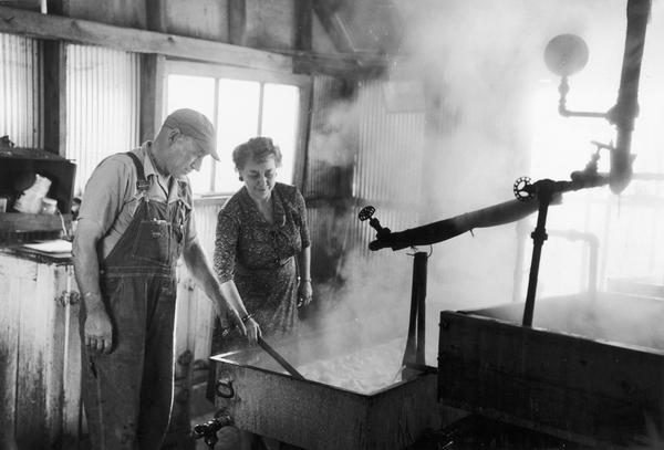 Aline W. Hazard, WHA Homemakers program director, visits a sorghum mill in Prairie du Chien for her on-the-spot reporting of unusual Wisconsin industries.