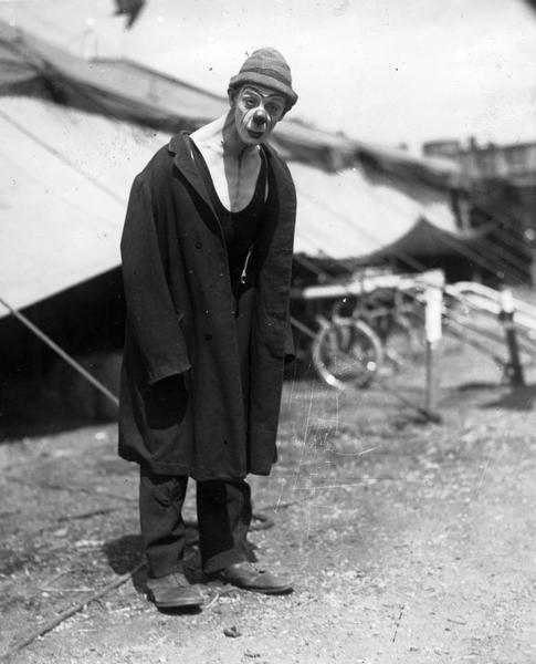 Circus clown, "Bumpsy" Anthony, stands in front of a tent.