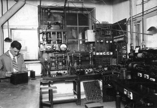 Malcolm Hanson at the University of Wisconsin-Madison radio station in the Department of Physics. Hanson helped to develop the radio station and equipment.