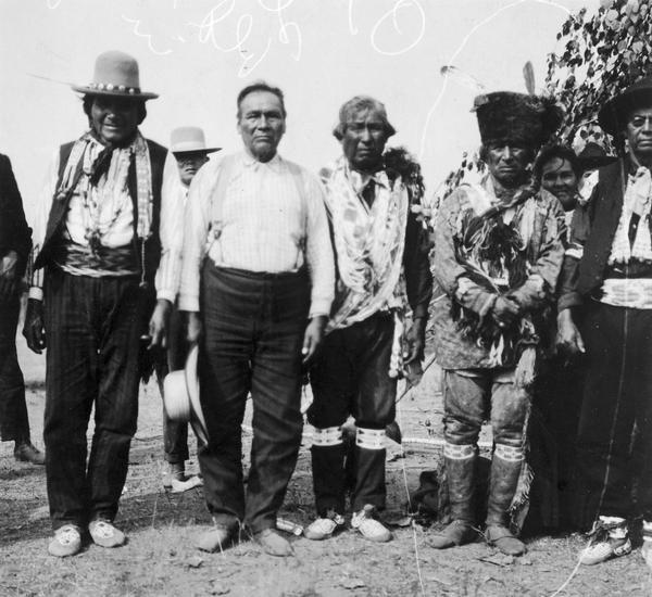 A group of prominent Menominee: (from left to right) Wisanokwut, Wiuskasit, Thomas Hog, Kesoafomesao, Louise Amore (or Amour), and Judge Perrote.  This photograph was used in an exhibit about Native Americans prepared by Paul Vanderbilt, the Wisconsin Historical Society's first curator of photography.