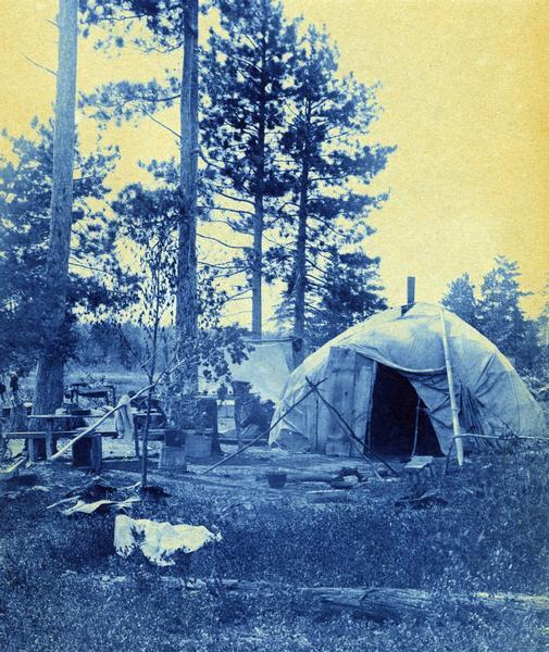 A wigwam covered with store canvas. This cyanotype image is part of an exhibit about Native Americans prepared by Paul Vanderbilt, first curator of photography at the Wisconsin Historical Society.
