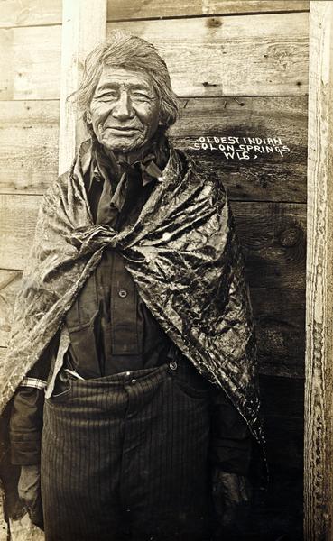 A portrait of an elderly Native American man identified only as "the oldest Indian, Solon Springs, Wisconsin."  This image is part of an exhibit about Native Americans prepared by Paul Vanderbilt, the first curator of photography at the Wisconsin Historical Society.