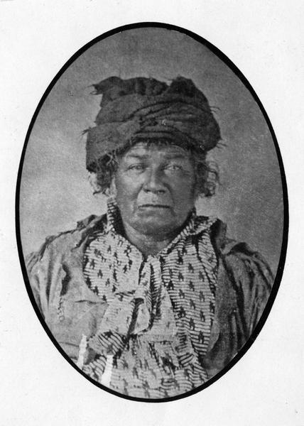 A formal portrait of the Potowatomie chief Shaubena or (Shabona) made at Hennepin, Illinois shortly before his death in 1859.  Shaubena was a grandnephew of Pontiac and he lived in Ohio, Iowa, Illinois, and Kansas.  He helped the Americans during the Black Hawk War in exchange for a small government pension, and was known to his Native American enemies as the "White Man's Friend."  This image is part of an exhibit about Native Americans prepared by Paul Vanderbilt, the Wisconsin Historical Society's first curator of photography.
