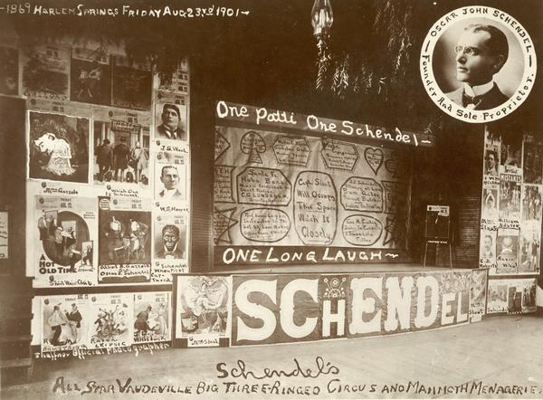The stage and surrounding posters of Professor Oscar John Schendel's "All Star Vaudeville, Big Three-Ringed Circus, and Mammoth Menagerie."