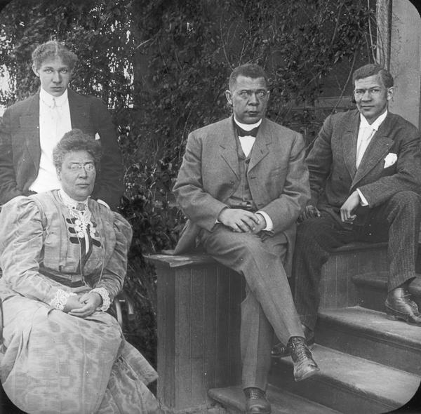 Outdoor formal portrait of Booker T. Washington with his wife and two sons.
