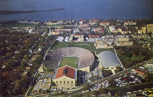 Aerial view of Camp Randall during a football game on the University of Wisconsin-Madison campus with Picnic Point in the background.