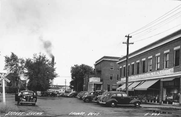 Leona street scene with parked cars in front of  Connor's Big Department Store and the Hotel Gordon, photographed sometime during the summer of 1941.  Soon, wartime gas rationing would lcurtail automobile shopping trips and travel.