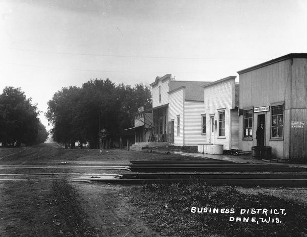 Railroad tracks cross the road at the central business district at Dane, Wisconsin.